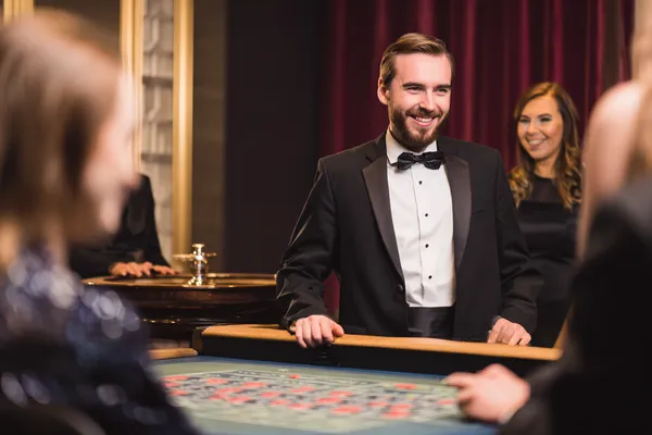 A woman in a luxurious green gown next to an ornate roulette wheel, capturing the upscale casino mood of 86JLPH.